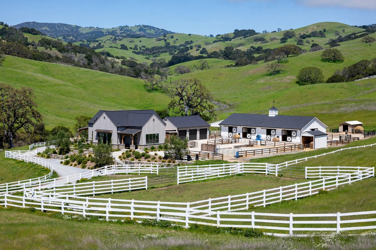 Equestrian estate with white fences in green hills, Portola Valley California