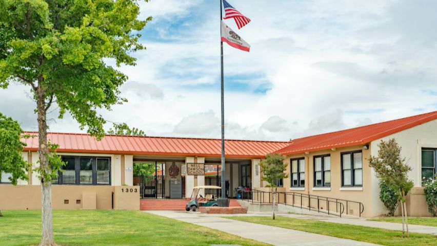 California elementary school campus building framed by trees